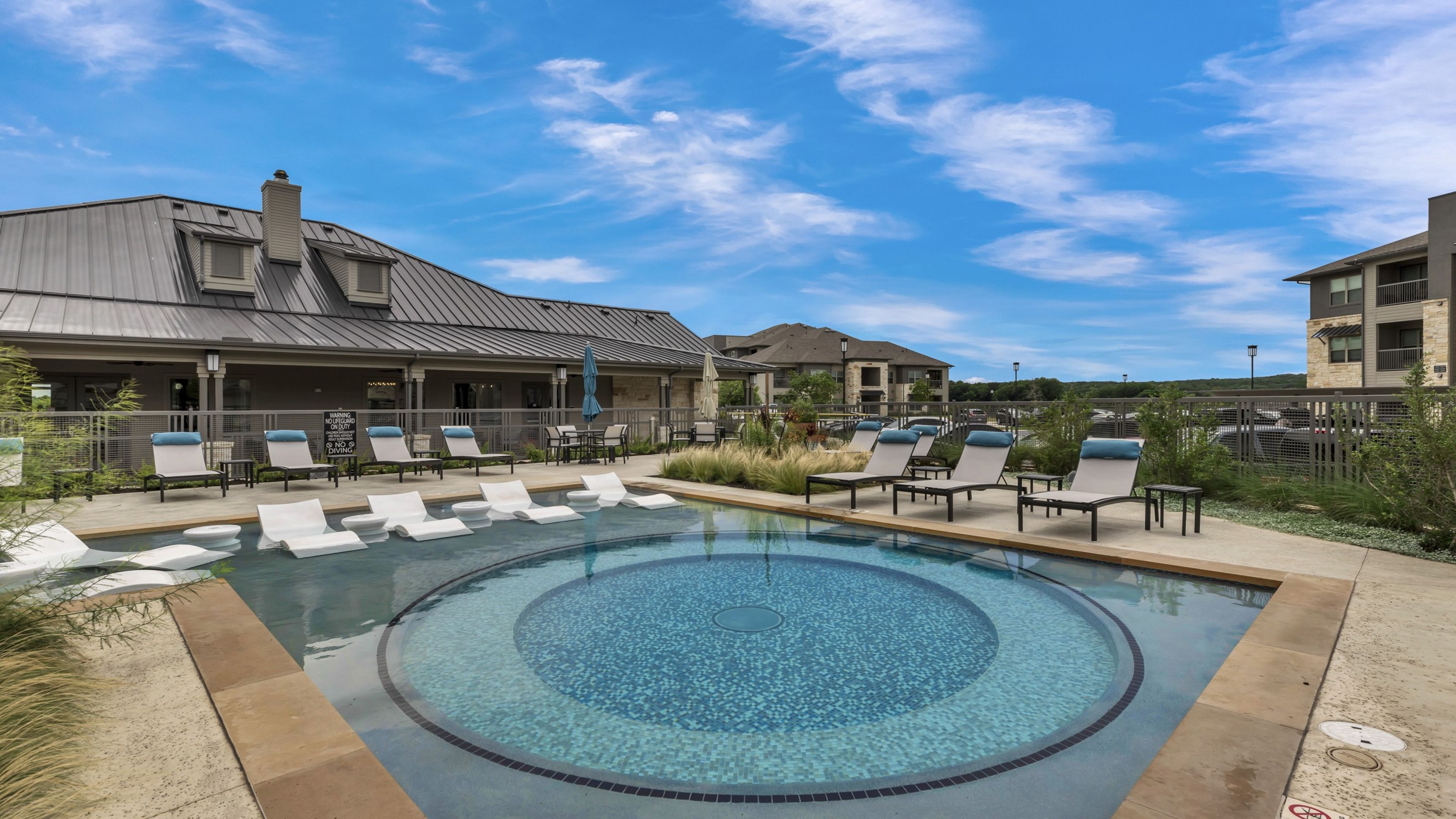 Hawthorne at Blanco Riverwalk luxury outdoor pool with in-pool lounge chairs and surrounding seating
